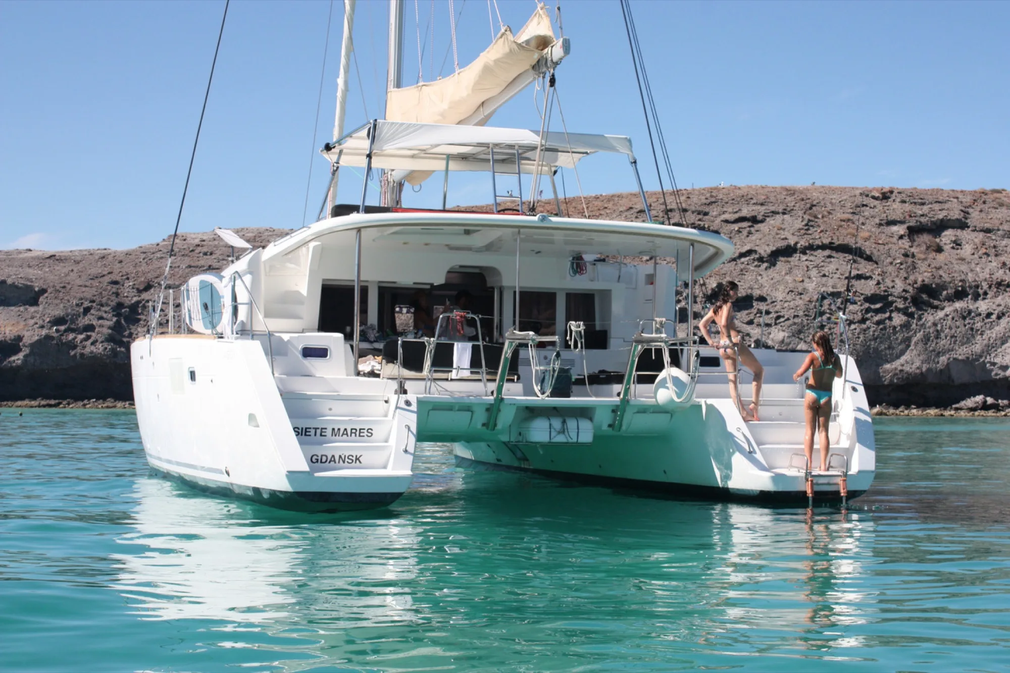 Guests on the swim platform of Siete Mares at anchor